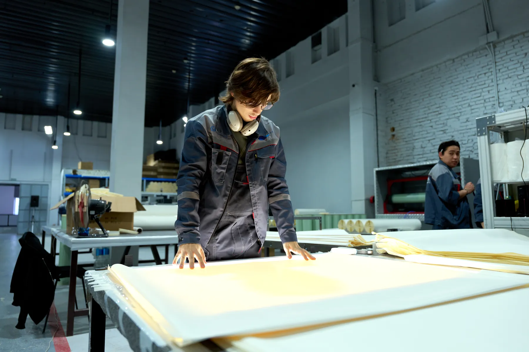 Quality-control specialist inspecting production materials in a manufacturing facility
